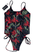 Floral patterned swimsuit with a tag on a white background